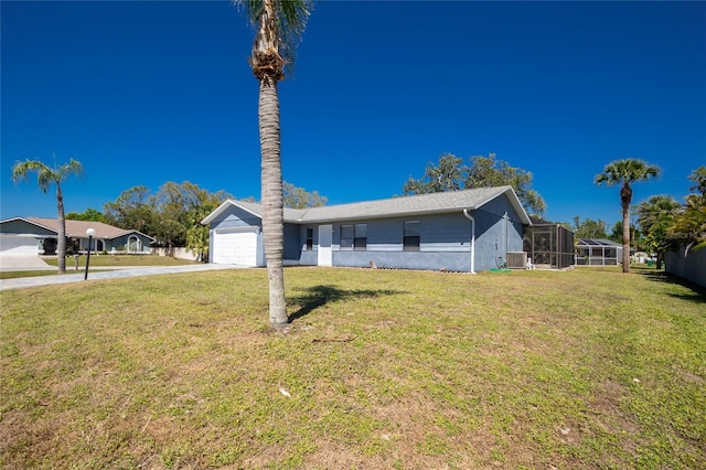 view of front of property with a front yard, a garage, driveway, and stucco siding