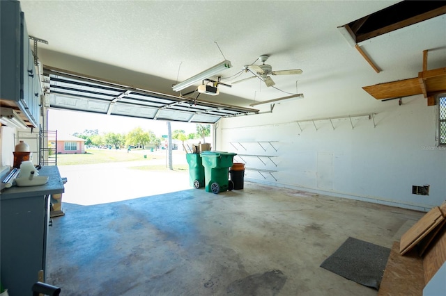 garage with a garage door opener and a ceiling fan