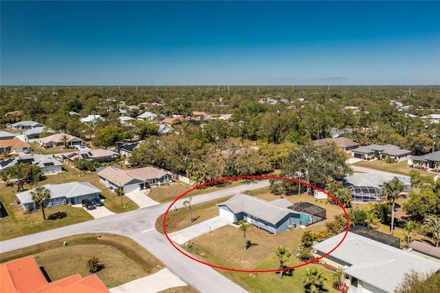 birds eye view of property with a residential view and a wooded view