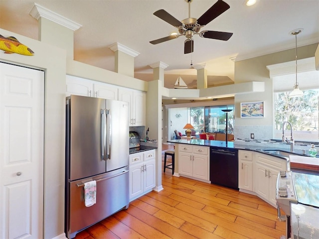 kitchen with freestanding refrigerator, black dishwasher, white cabinetry, dark countertops, and range