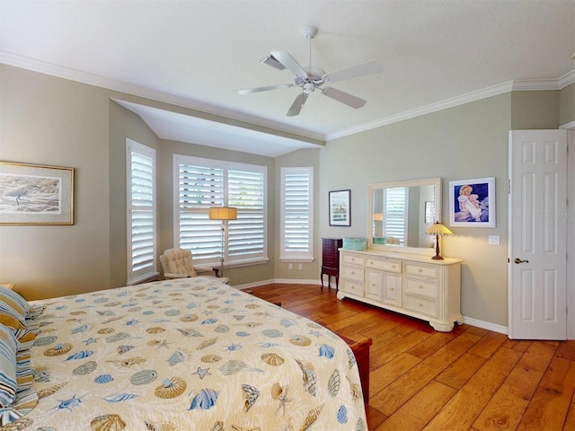 bedroom featuring light wood-type flooring, baseboards, ceiling fan, and crown molding