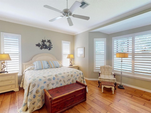 bedroom featuring visible vents, light wood-style flooring, and crown molding