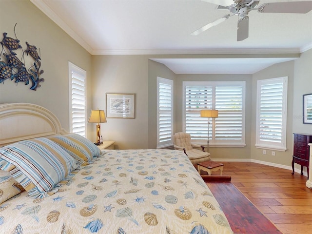 bedroom with ceiling fan, baseboards, wood finished floors, and ornamental molding