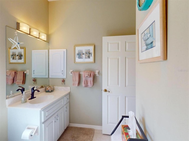 bathroom with vanity, tile patterned floors, and baseboards