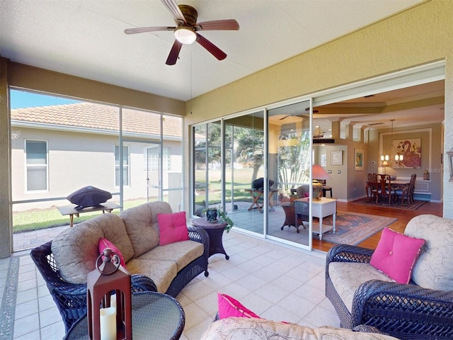 sunroom / solarium featuring ceiling fan