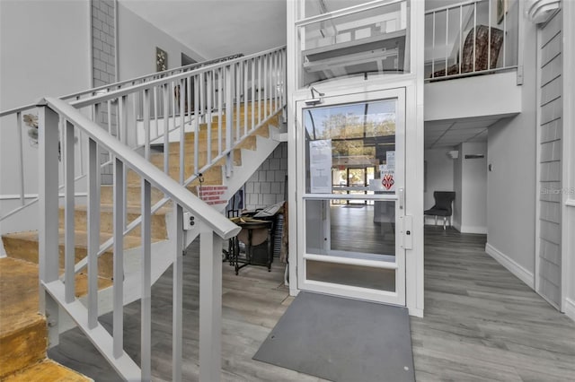 stairway featuring baseboards and wood finished floors