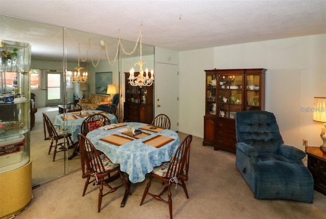 dining room with an inviting chandelier and carpet