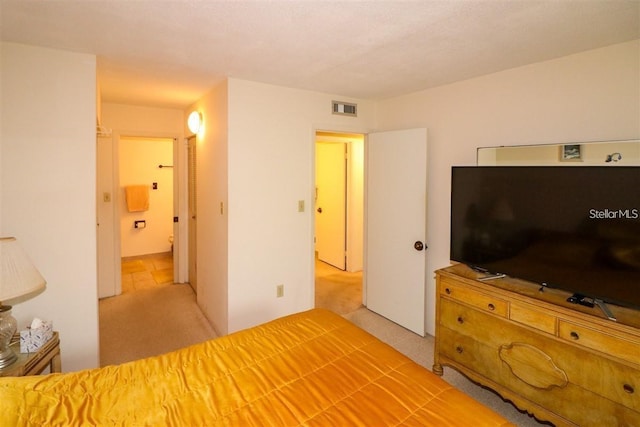 unfurnished bedroom featuring visible vents, carpet floors, and connected bathroom