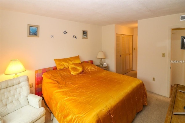 carpeted bedroom featuring visible vents and a closet