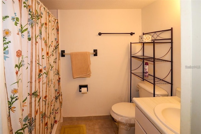 bathroom featuring tile patterned floors, toilet, curtained shower, baseboards, and vanity