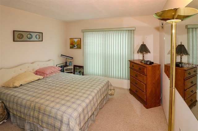 bedroom featuring light colored carpet