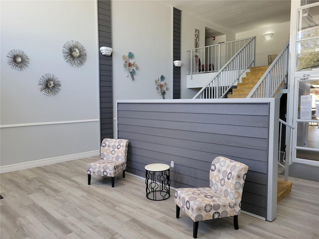 sitting room featuring stairway and wood finished floors