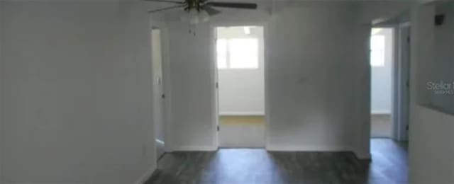 unfurnished room with baseboards and wood finished floors