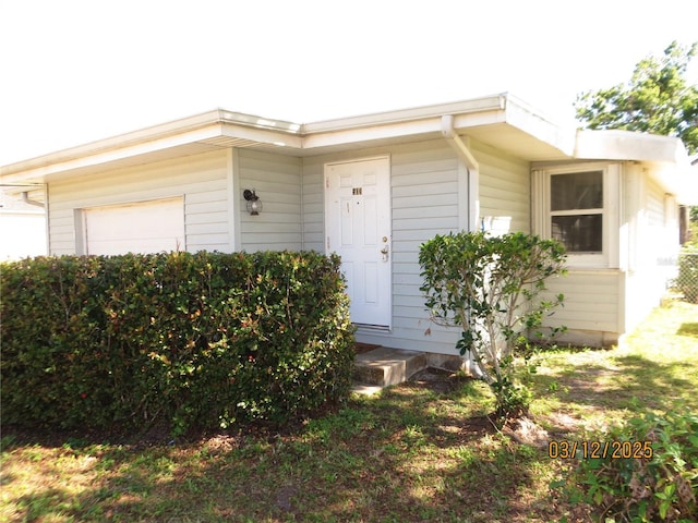 view of exterior entry with an attached garage