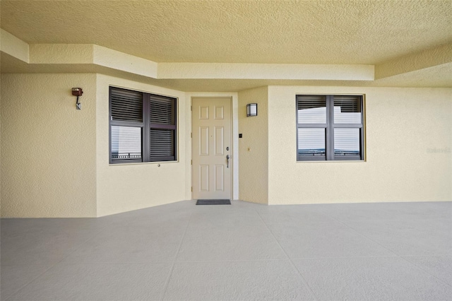 property entrance with stucco siding