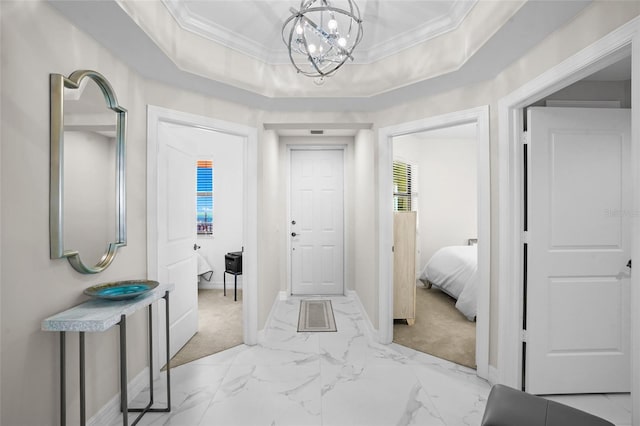 corridor with crown molding, baseboards, marble finish floor, and a raised ceiling