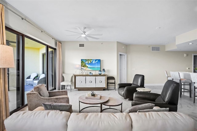 living room featuring visible vents, marble finish floor, and a ceiling fan