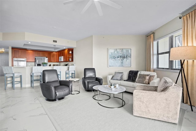 living area featuring recessed lighting, marble finish floor, visible vents, and ceiling fan