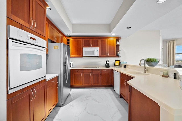 kitchen with a sink, a peninsula, marble finish floor, white appliances, and open shelves