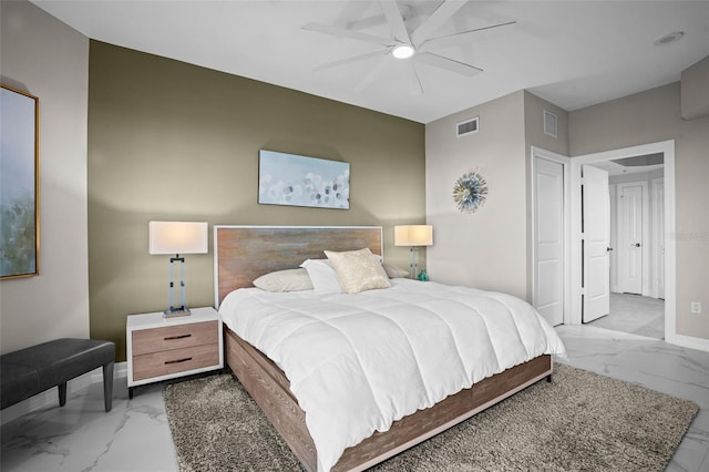 bedroom featuring visible vents, marble finish floor, a ceiling fan, and baseboards