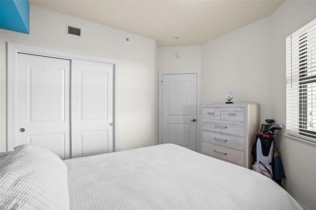 bedroom featuring a closet and visible vents