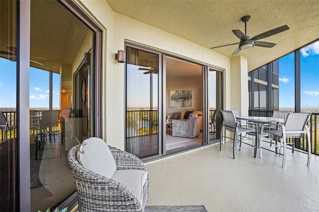 sunroom featuring a ceiling fan