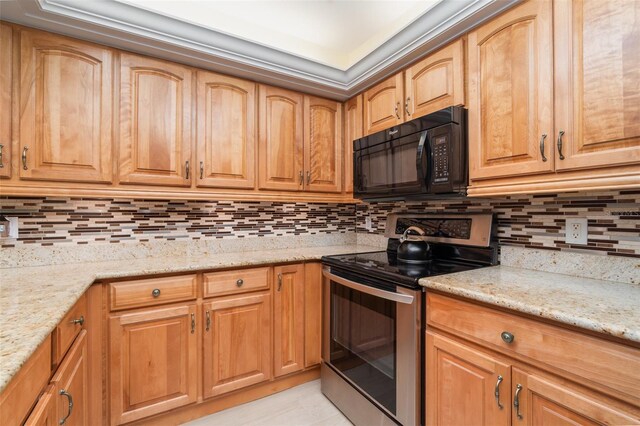 kitchen with light stone counters, stainless steel electric stove, black microwave, and decorative backsplash