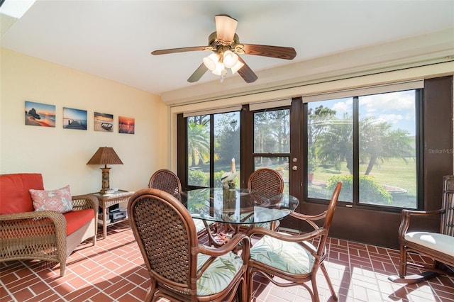 sunroom featuring ceiling fan