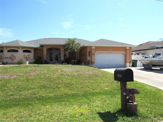 view of front of home featuring stucco siding, a front lawn, driveway, french doors, and an attached garage