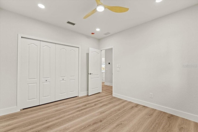 unfurnished bedroom featuring baseboards, visible vents, light wood finished floors, recessed lighting, and a closet