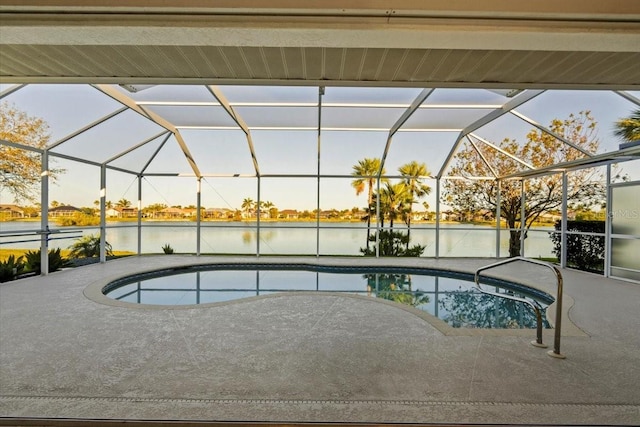 pool with a patio, a lanai, and a water view