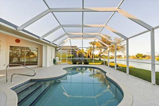 pool with a patio area, a lanai, and a water view