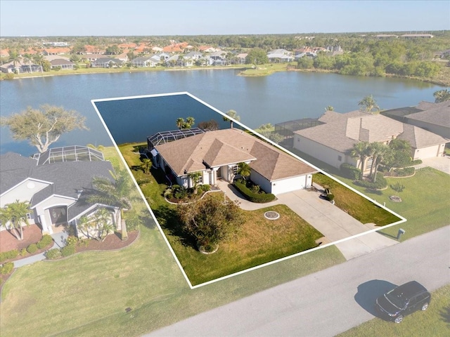 drone / aerial view featuring a residential view and a water view
