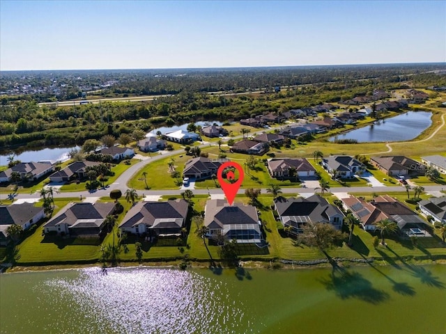 birds eye view of property with a residential view and a water view