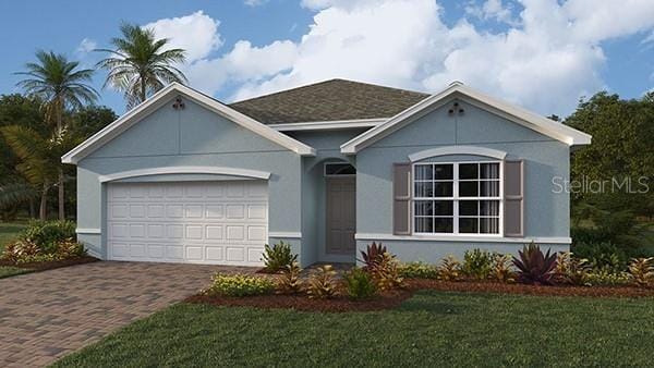 view of front of house with stucco siding, an attached garage, decorative driveway, and a front yard