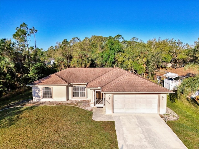 ranch-style house with stucco siding, an attached garage, concrete driveway, and a front yard