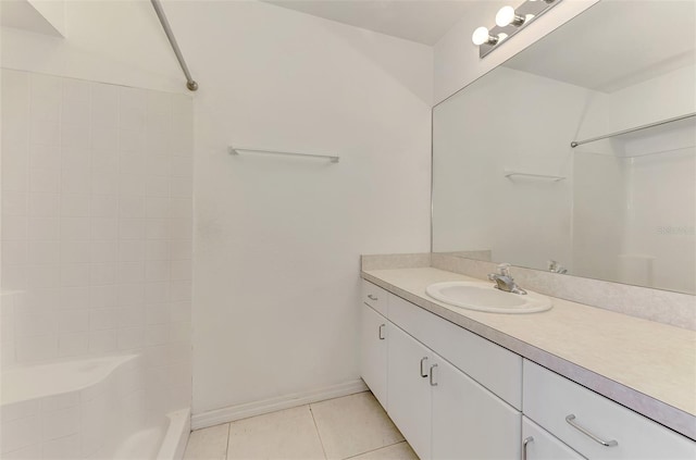 bathroom featuring tile patterned floors, baseboards, walk in shower, and vanity