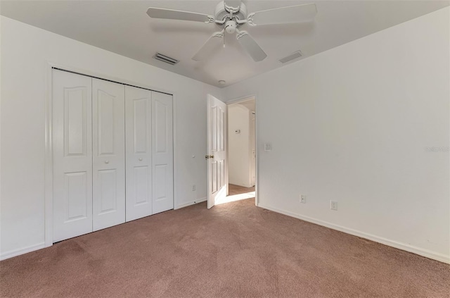 unfurnished bedroom featuring visible vents, baseboards, carpet, and a closet