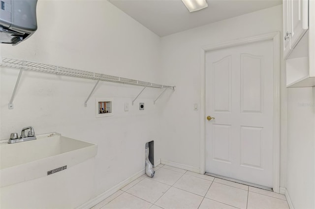 laundry area featuring hookup for an electric dryer, laundry area, light tile patterned flooring, a sink, and washer hookup