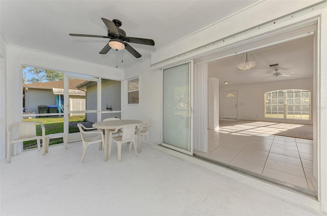 sunroom featuring ceiling fan