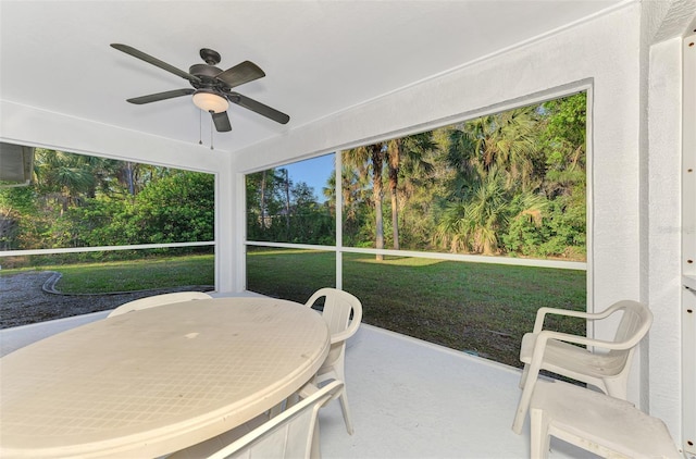 sunroom featuring a ceiling fan