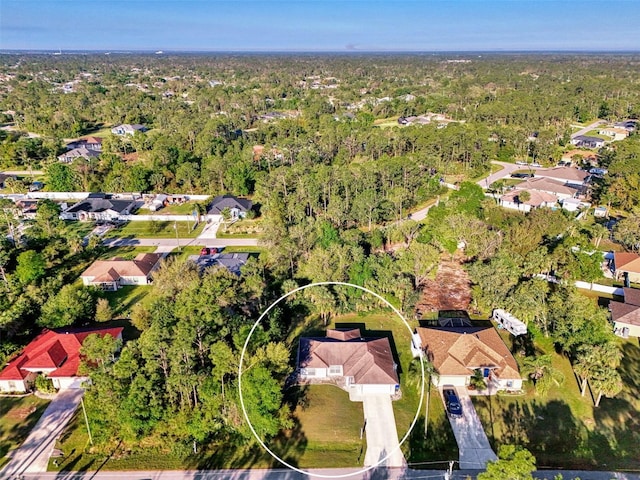 drone / aerial view with a residential view and a forest view