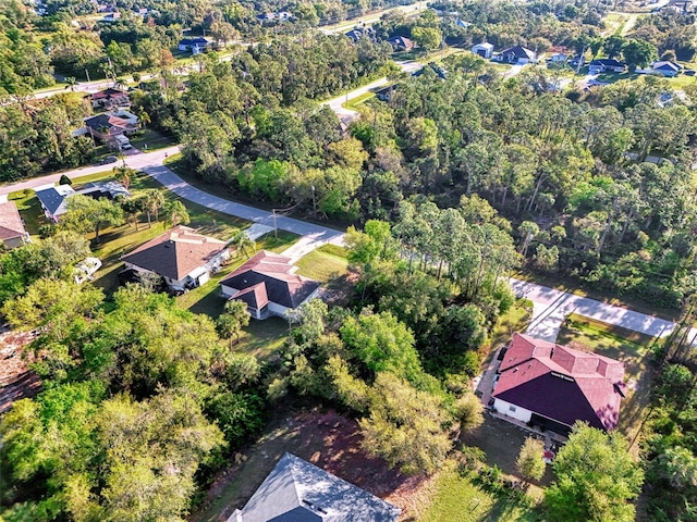 birds eye view of property with a view of trees