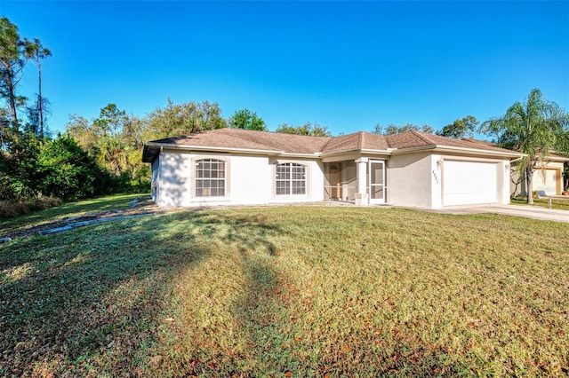 view of front of property with stucco siding, an attached garage, concrete driveway, and a front lawn