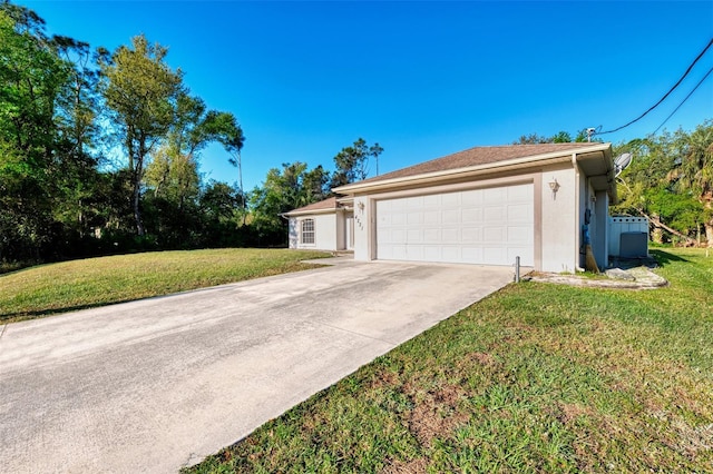 view of side of property featuring stucco siding, a yard, concrete driveway, and an attached garage