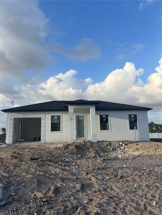 view of front of property featuring stucco siding and a garage