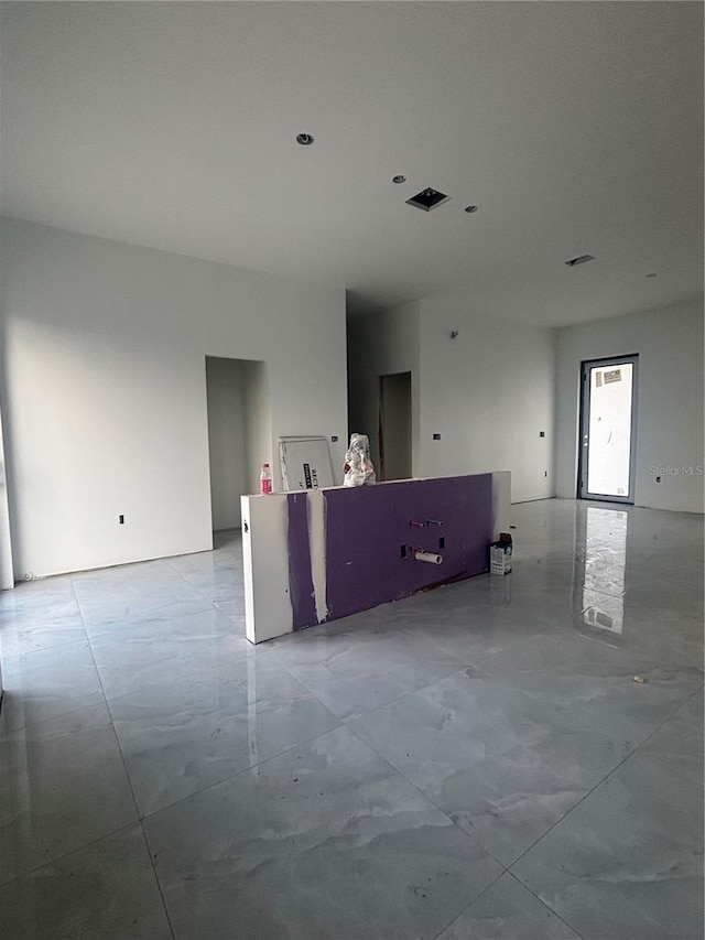 spare room featuring marble finish floor