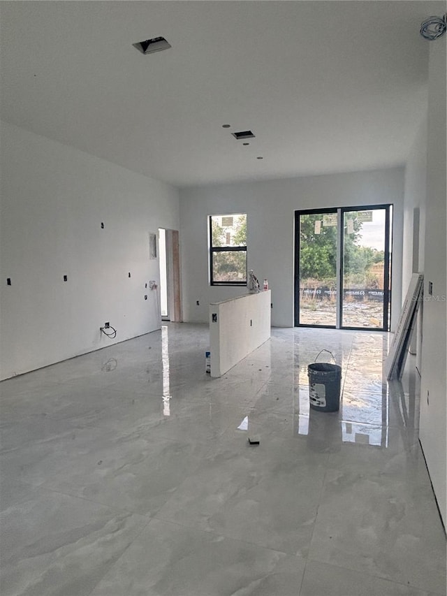 unfurnished living room with visible vents