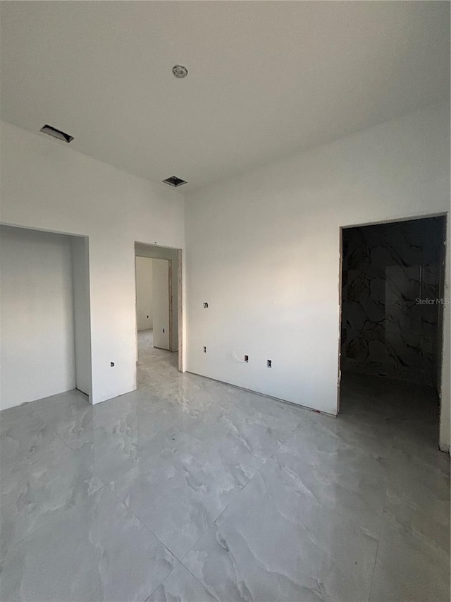 unfurnished bedroom with visible vents and marble finish floor