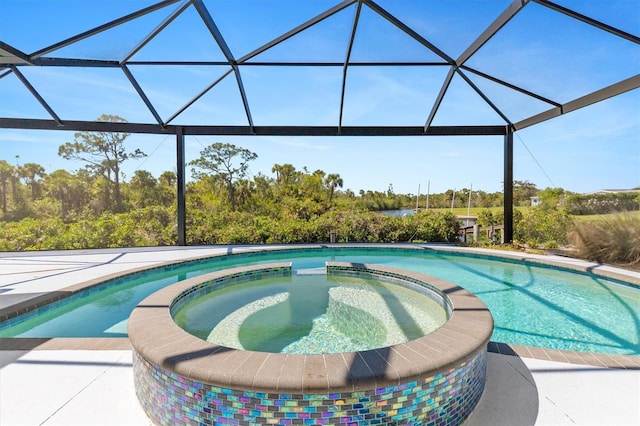 view of pool with a lanai and a pool with connected hot tub